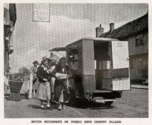 Several customers gather at a mobile canteen van in a residential street in the 1940s.
