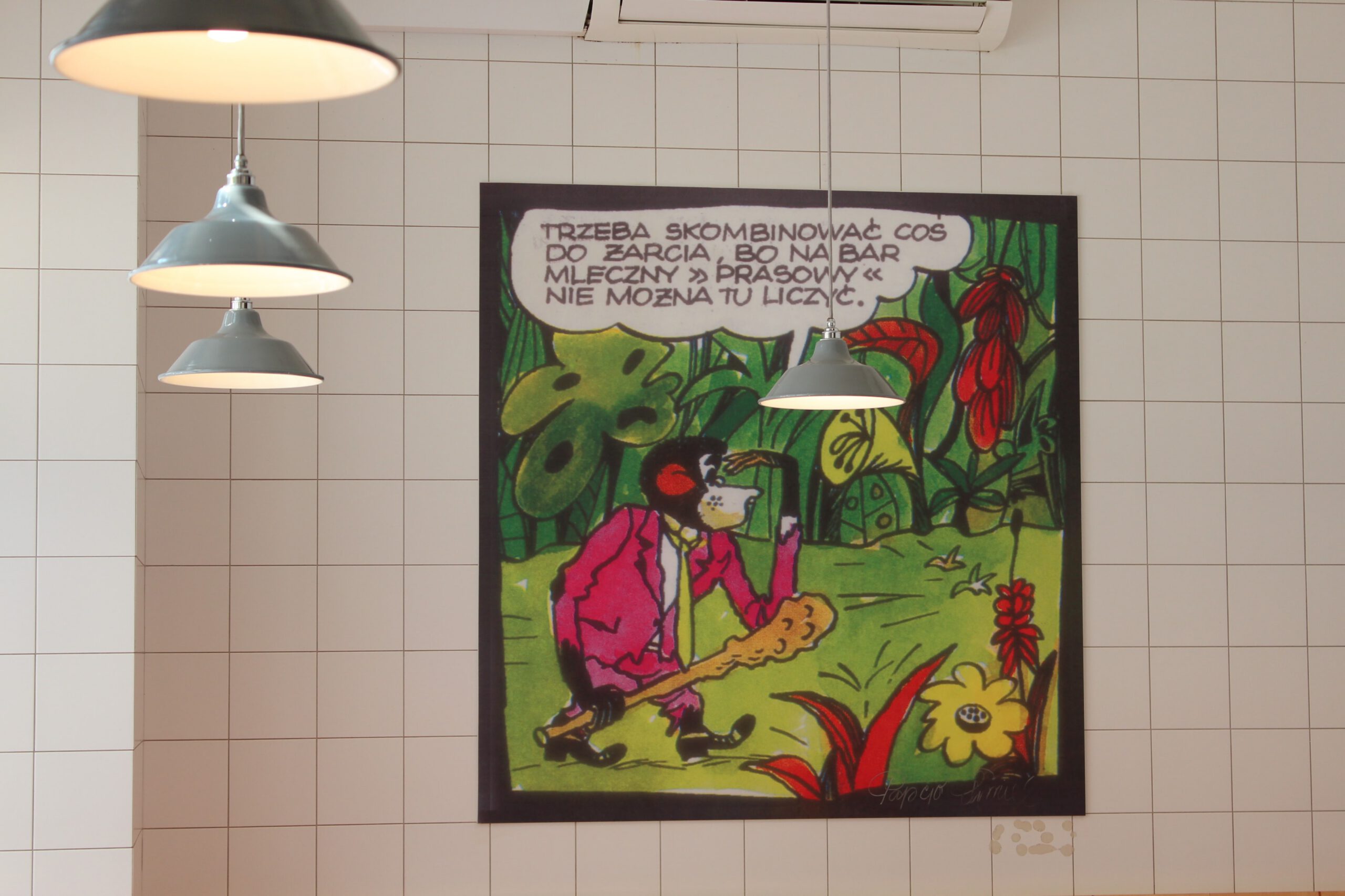 Art on the wall of a milk bar, featuring a monkey carrying a club, rendered in a comic art style.