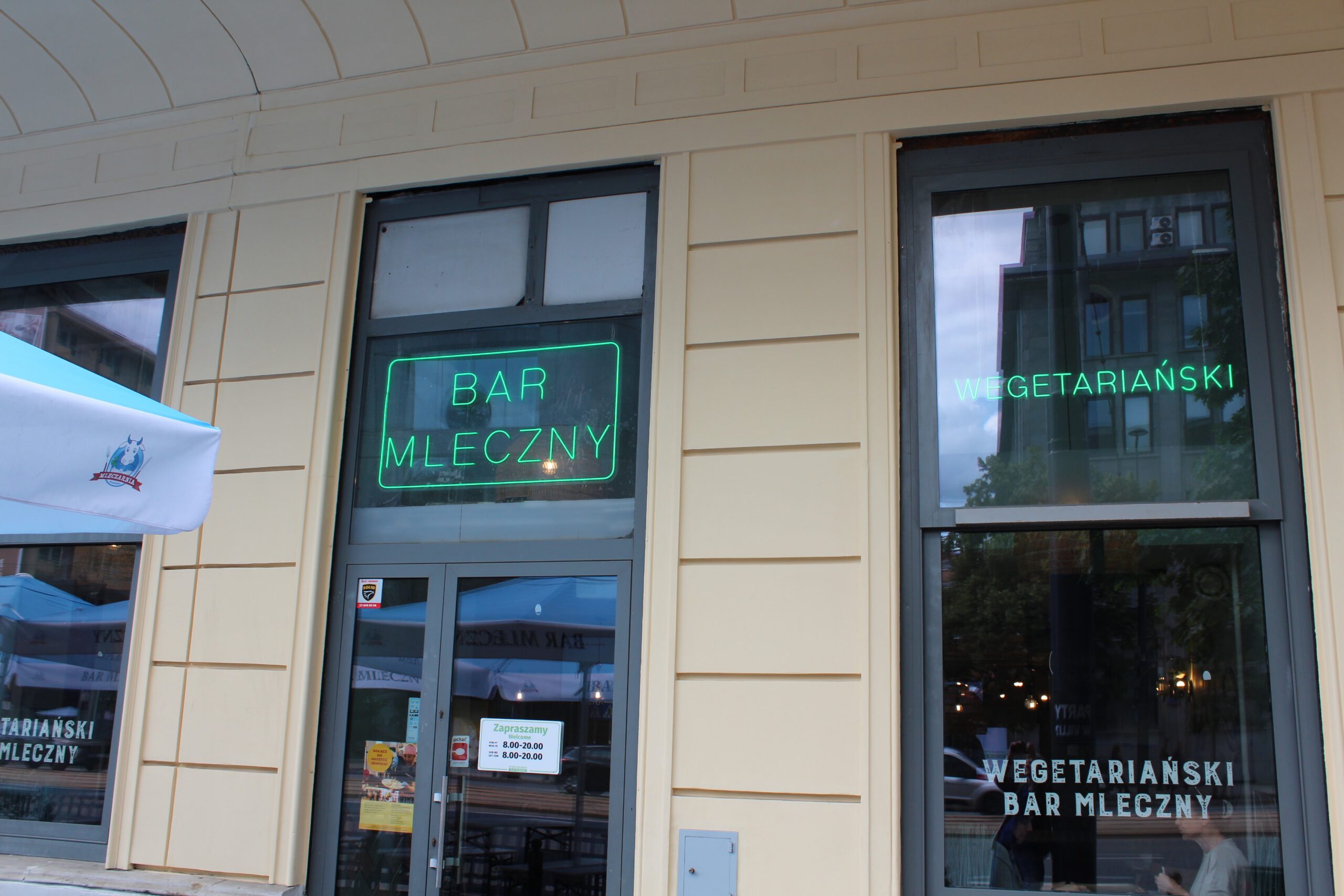 Outside view of Polish milk bar, advertising vegetarian food