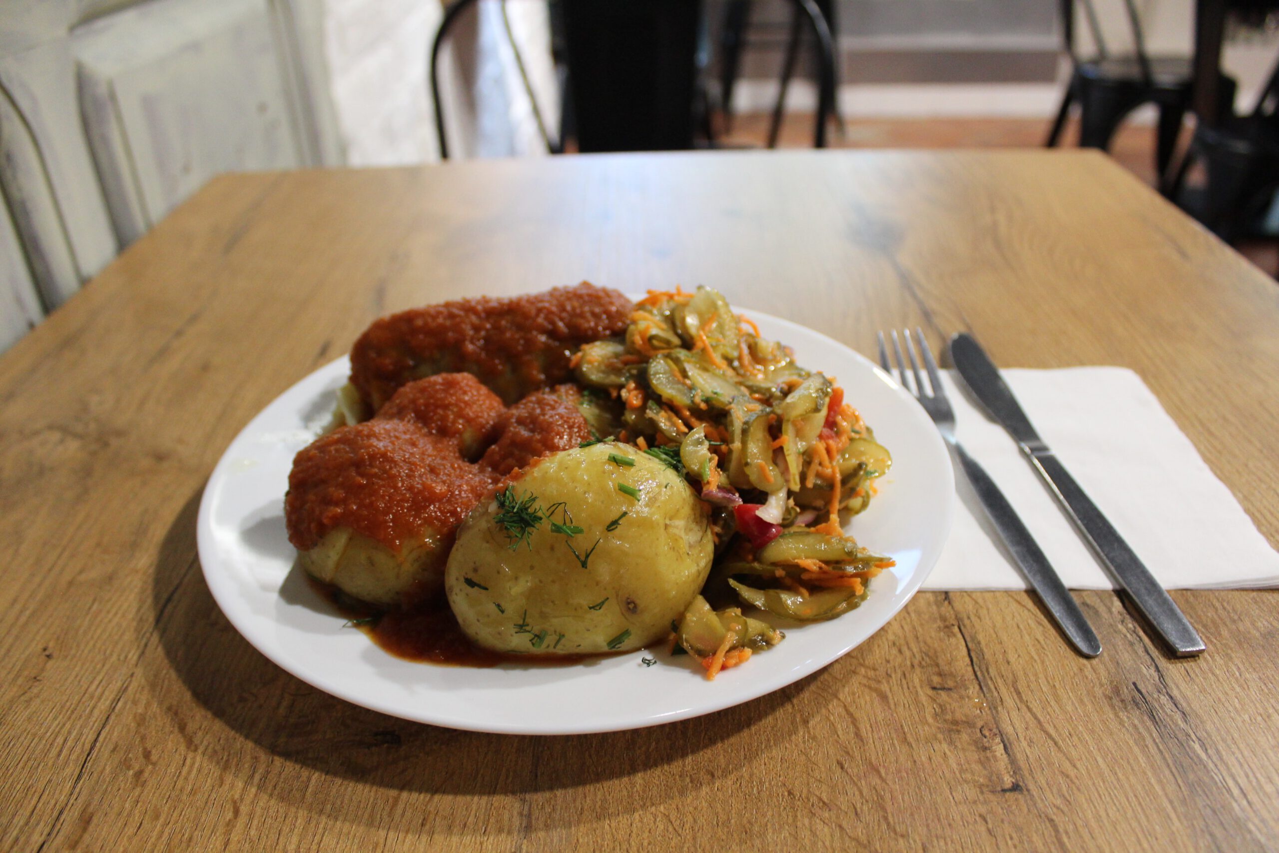 Very tasty looking potato and tomato based meal on table in cafe